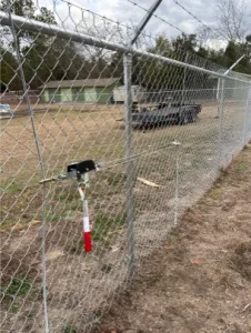 A chain link fence guarding a field.