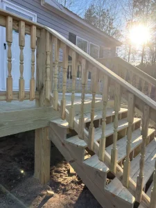 Close up of wooden steps leading up to a home.