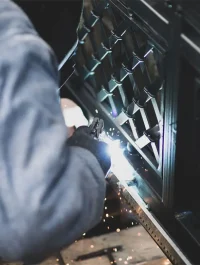 Welder welds the steel gear racks to gate before setting up automated gate operator.